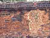 Brickwork patched with cement mortar