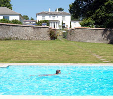 Outdoor heated swimming pool in walled garden